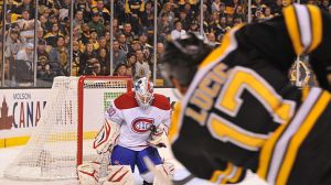 Milan Lucic #17 of the Boston Bruins shoots the puck against Peter Budaj #30 of the Montreal Canadiens