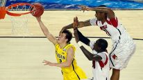 Spike Albrecht #2 of the Michigan Wolverines drives for a shot attempt against Gorgui Dieng #10 and Chane Behanan #21 of the Louisville Cardinals during the 2013 NCAA Men's Final Four Championship at the Georgia Dome on April 8, 2013 in Atlanta, Georgia.