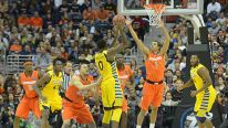 Marquette forward Jamil Wilson (0) tries to pass to the inside over Syracuse guard Michael Carter-Williams 