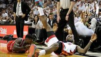 Miami Heat forward LeBron James looks up for the ball after diving on the floor next to Chicago Bulls guard Nate Robinson during the second quarter in the NBA Eastern Conference playoffs at the AmericanAirlines Arena in Miami, Florida, Monday, May 6, 2013