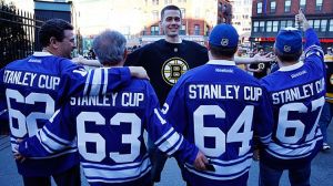 A Boston Bruins fan and a group of Toronto Maple Leafs fans