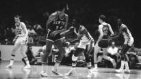 Philadelphia 76ers guard Fred Carter (3) reaches for the ball, but New York Knicks guard Walt Frazier (10) flicks it behind his back to a teammate in the first quarter of an NBA game in Philadelphia on Wednesday, Nov. 20, 1974.