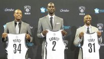 Kevin Garnett #2, Paul Pierce #34, and Jason Terry #31 of the Brooklyn Nets pose with their new jerseys during a press conference at the Barclays Center on July 18, 2013 in the Brooklyn borough of New York City.