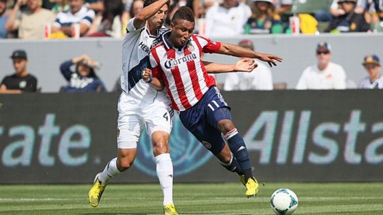 Omar Gonzalez #4 of the Los Angeles Galaxy and Juan Agudelo #11 of Chivas USA