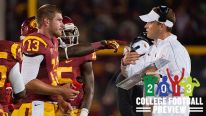Head Coach Lane Kiffin and Max Wittek #13 of the USC Trojans talk on the sideline during a 22-13 loss against the Notre Dame Fighting Irish at Los Angeles Memorial Coliseum on November 24, 2012 in Los Angeles, California.