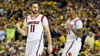 Luke Hancock #11 and Chane Behanan #21 of the Louisville Cardinals celebrate after they won 72-68 against the Wichita State Shockers during the 2013 NCAA Men's Final Four Semifinal at the Georgia Dome on April 6, 2013 in Atlanta, Georgia.