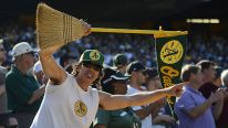 An Oakland Athletics fan holds up a broom for the series sweep against the Texas Rangers at O.co Coliseum on October 3, 2012 in Oakland, California. The Athletics won the game 12-5 capturing the American League West title.