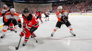 Claude Giroux #28 of the Philadelphia Flyers and Andrei Loktionov #21 of the New Jersey Devils