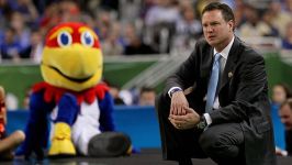 Head coach Bill Self of the Kansas Jayhawks reacts in the first half as the Jayhawks mascot looks over at him as the Jayhawks take on the Ohio State Buckeyes during the National Semifinal game of the 2012 NCAA Division I Men's Basketball Championship at t