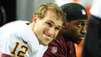 Kirk Cousins #12 of the Washington Redskins chats with Robert Griffin III