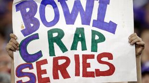 A fan holds up a 'Bowl Crap Series' sign to mock the BCS