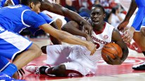 Fred Gulley III #12 of the Arkansas Razorbacks battles for a loose ball on the floor against the Kentucky Wildcats at Bud Walton Arena on January 14, 2014 in Fayetteville, Arkansas