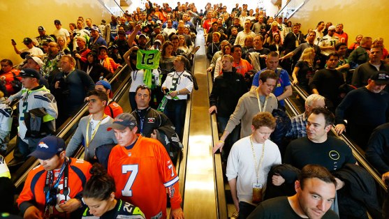 Football fans make their way to trains on Sunday, Feb. 2, 2014, in Secaucus, N.J. The Seattle Seahawks are scheduled to play the Denver Broncos in NFL football's Super Bowl XLVIII game on Sunday evening at MetLife Stadium in East Rutherford, N.J.